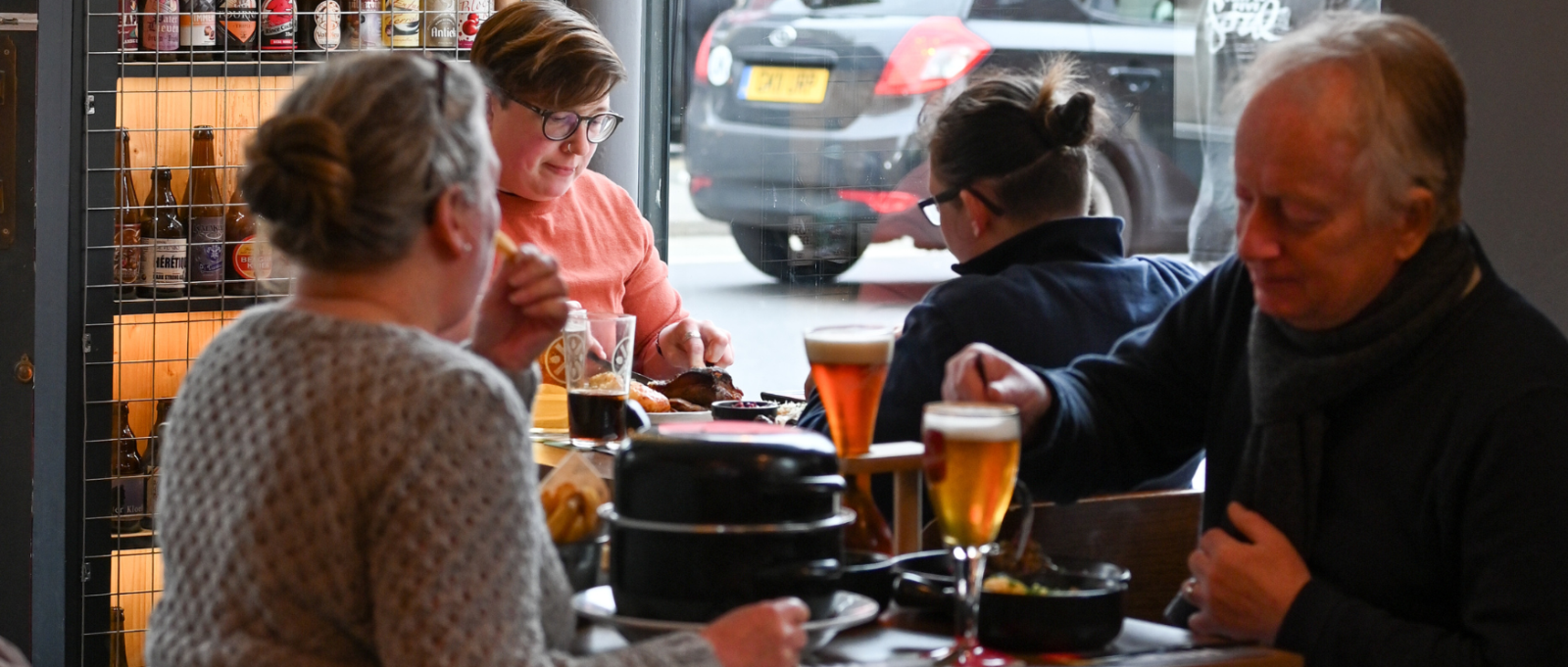 Customers sit around a table at Huis